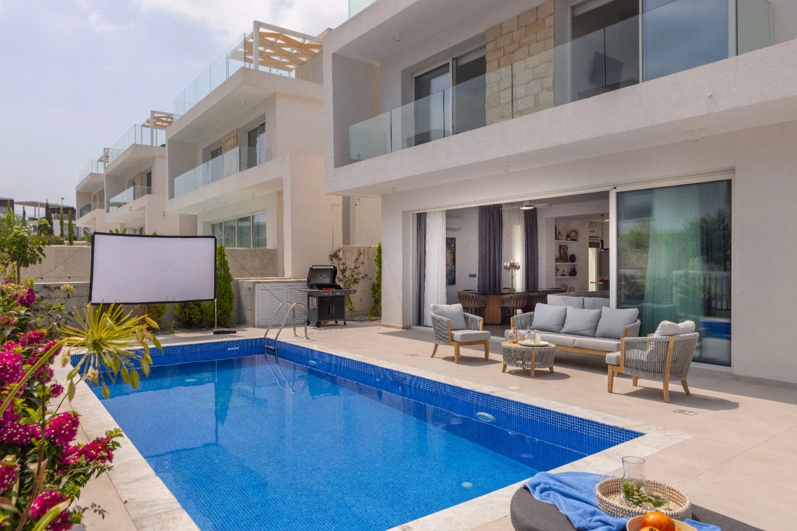 The villa facade with the outdoor cinema set up in front of it.
