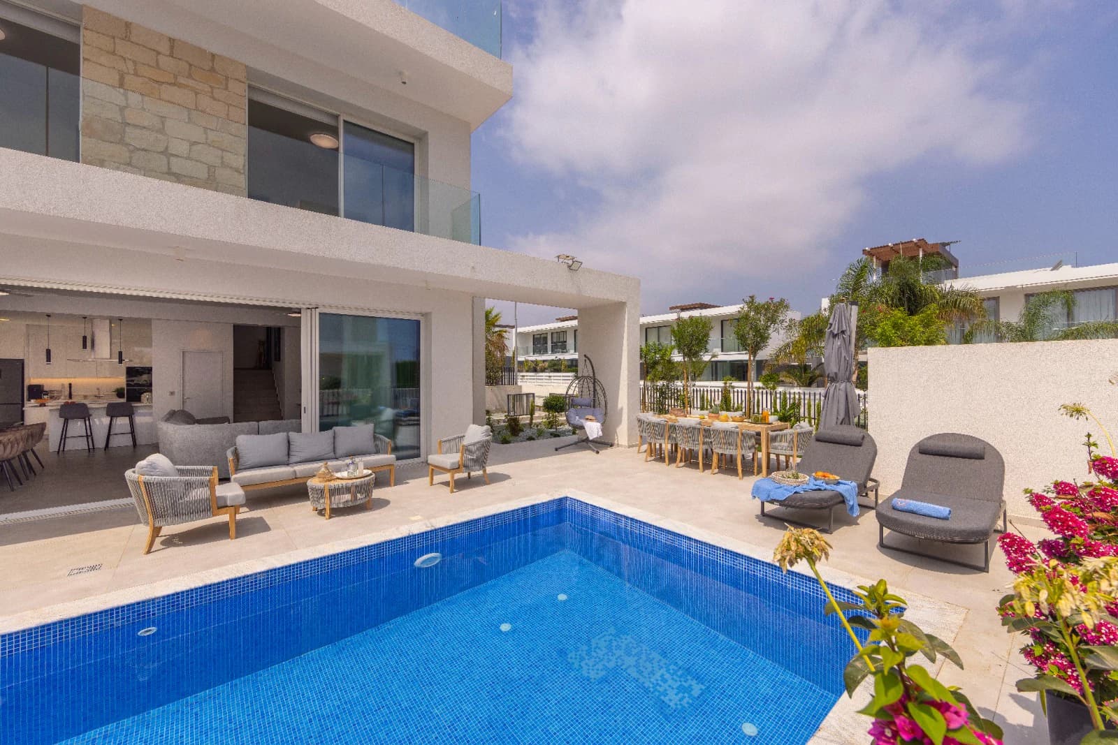 The villa facade with bougainvillea along the poolside.