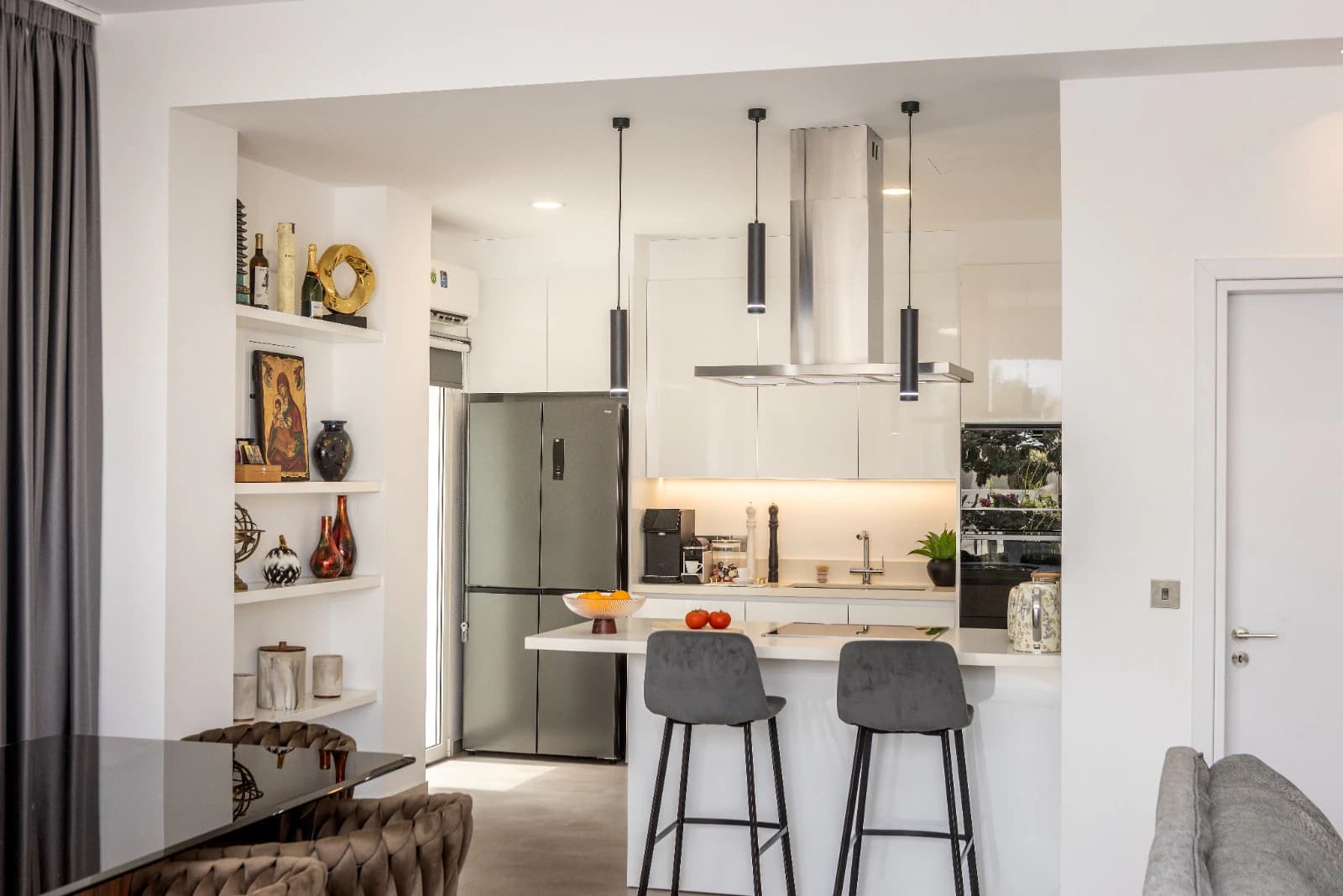 The living and dining area, open along its full width to the pool terrace.