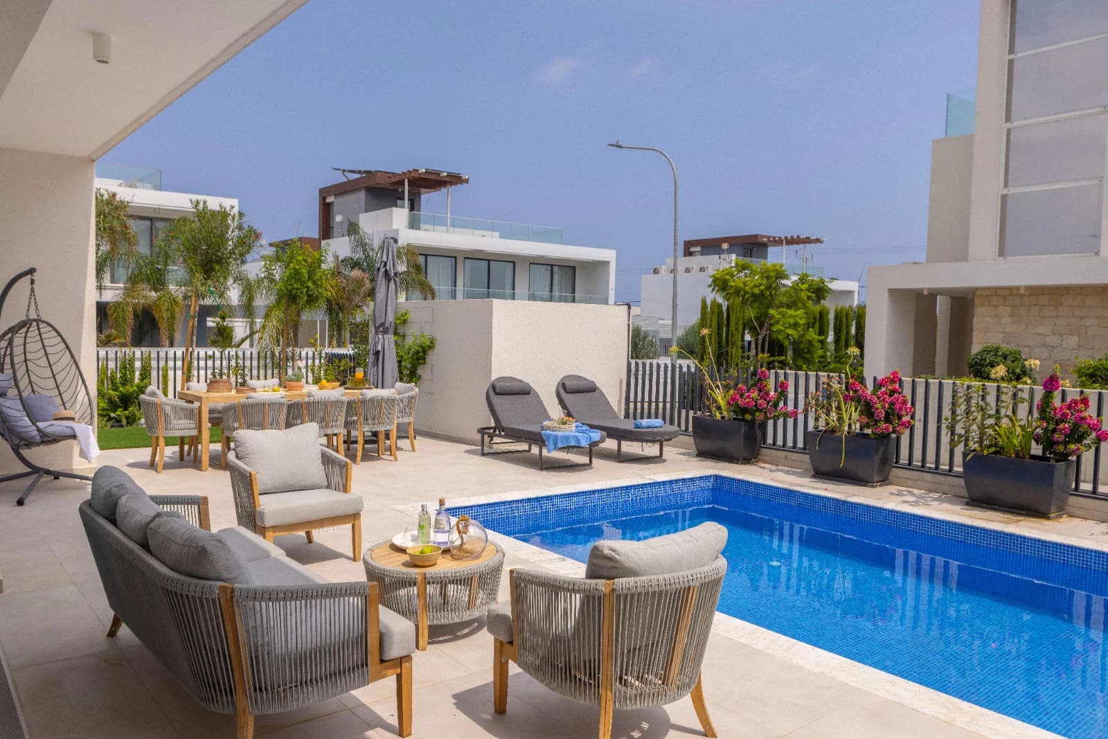 Lounge seating and a dining table on the pool terrace.
