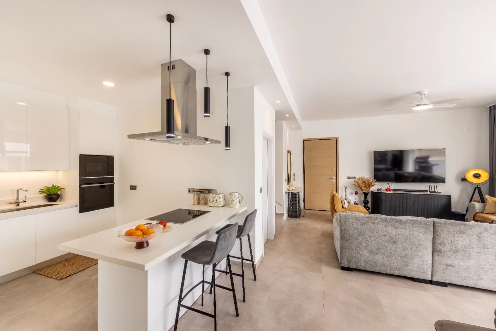 The kitchen island and breakfast bar, open along its length to the living room beyond.